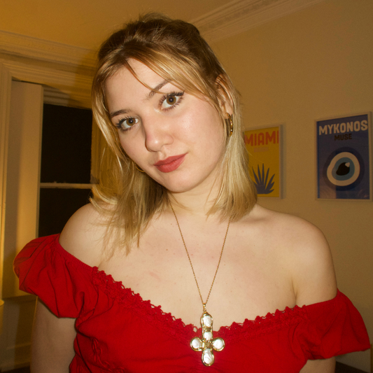 Daisy's gold cross necklace