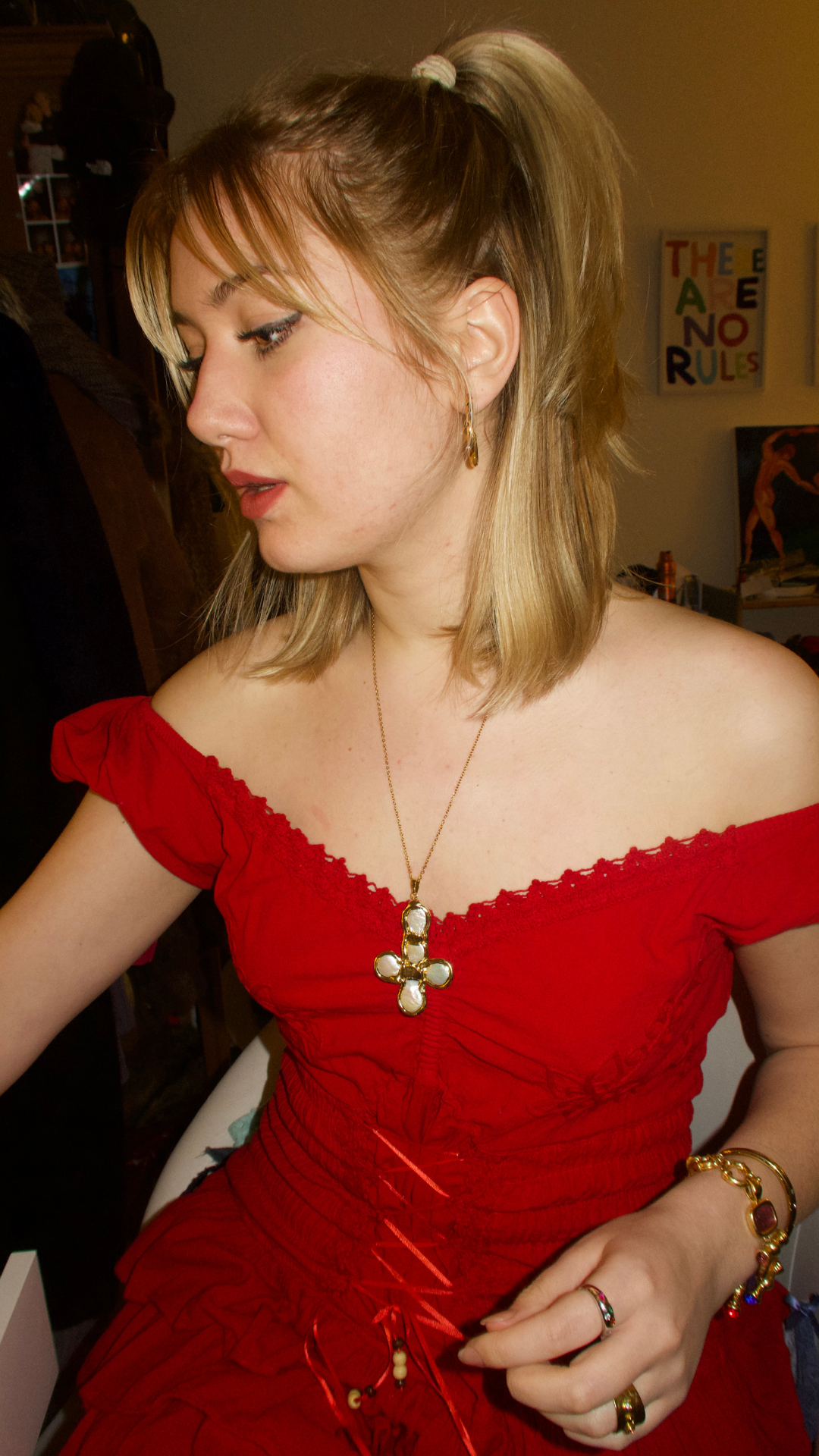 Daisy's gold cross necklace is