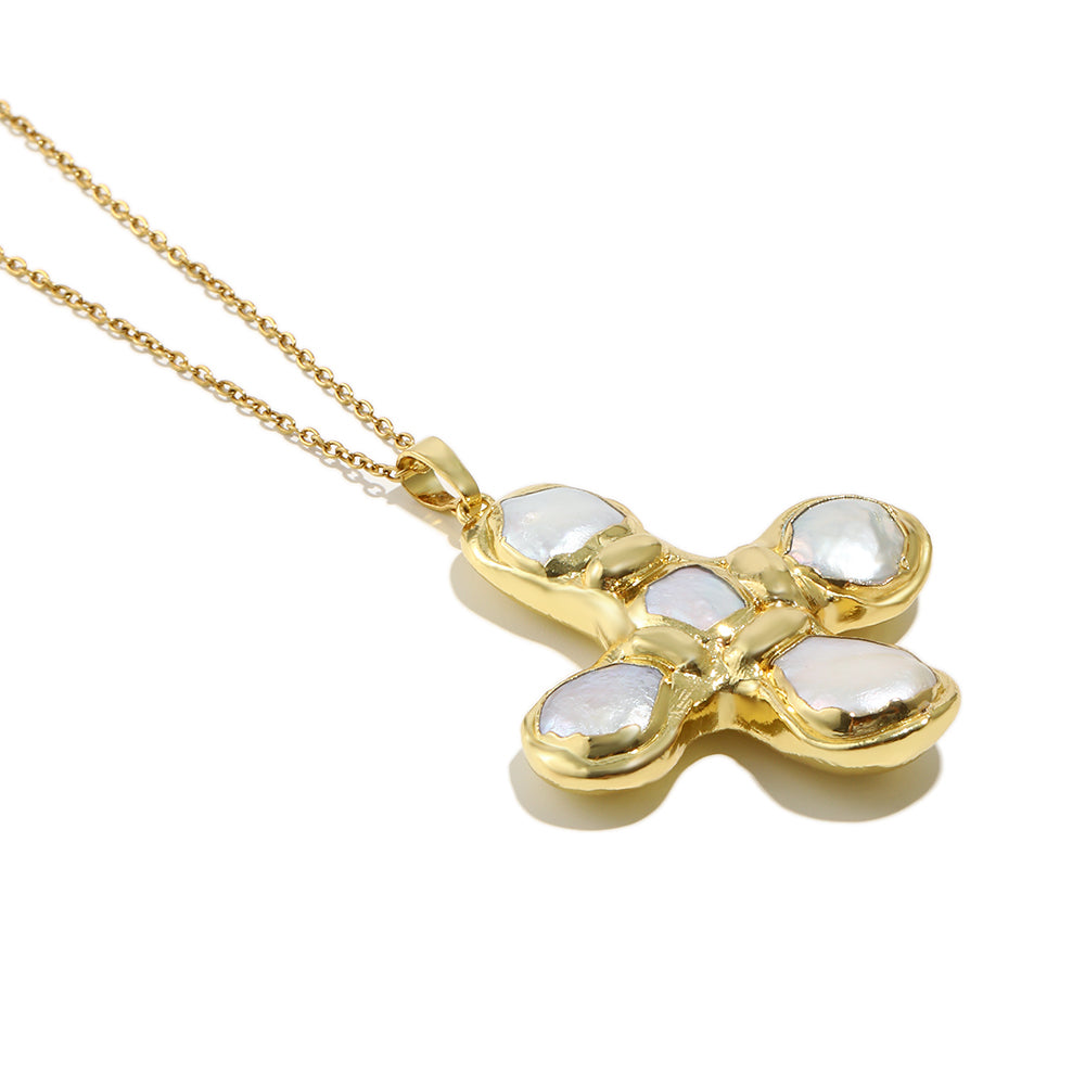 Daisy's gold cross necklace is