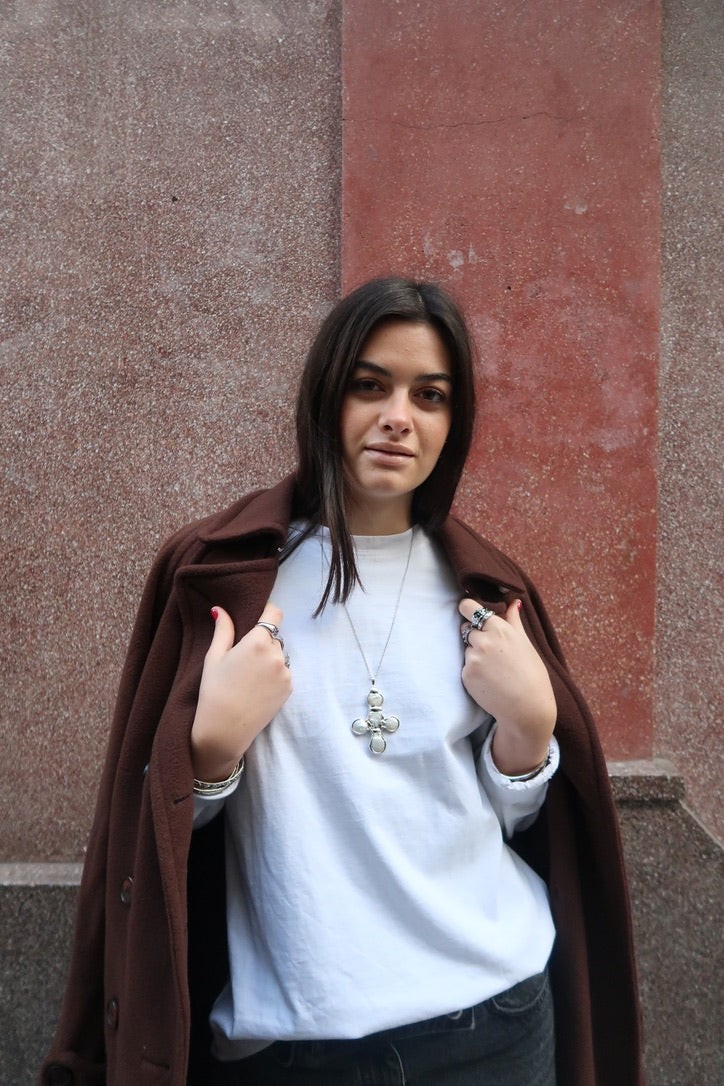 Daisy's silver cross necklace