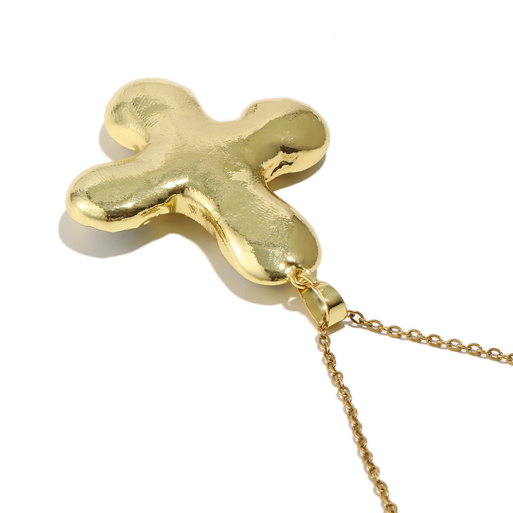 Daisy's gold cross necklace is