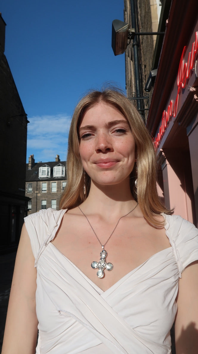 Daisy's silver cross necklace