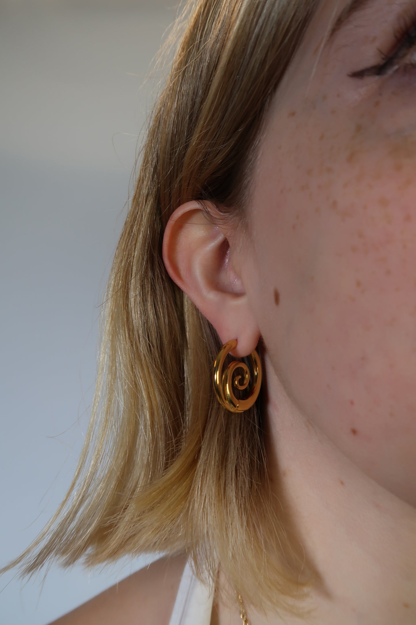 Tilly’s gold swirl earrings