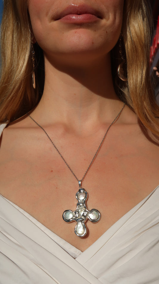 Daisy's silver cross necklace
