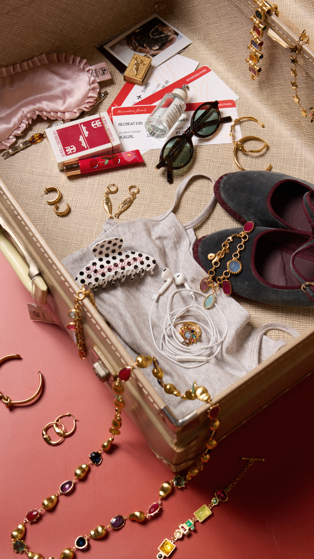 Recreation Jewels gold jewellery spilling out of a vintage suitcase